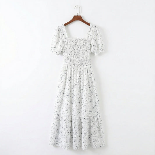 Floral dress on a hanger against a white background